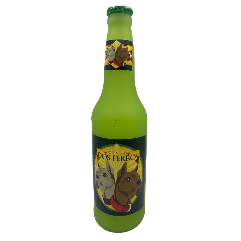 The front of the Dos Perros Squeak Toy. It is green and is shaped like a beer bottle. It has a large label with two dogs and the words "Cerveza, Dos Perros". The cap is a darker green.